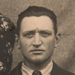 Old black and white portrait with facial blurring and surface spots