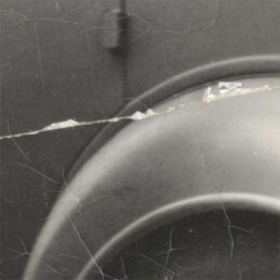 Old black and white photo with deep cracks and surface damage restored to original clarity.